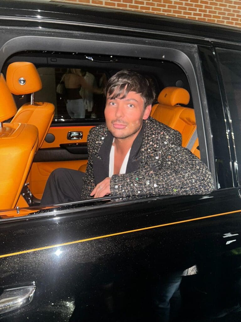 Chris Henderson photographed pulling up to a fashion week event in a Rolls Royce